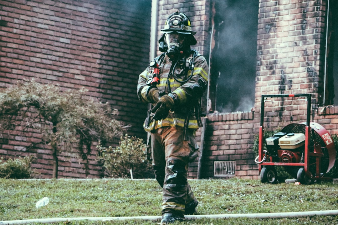Restoration crew cleaning up a room after smoke and fire damage